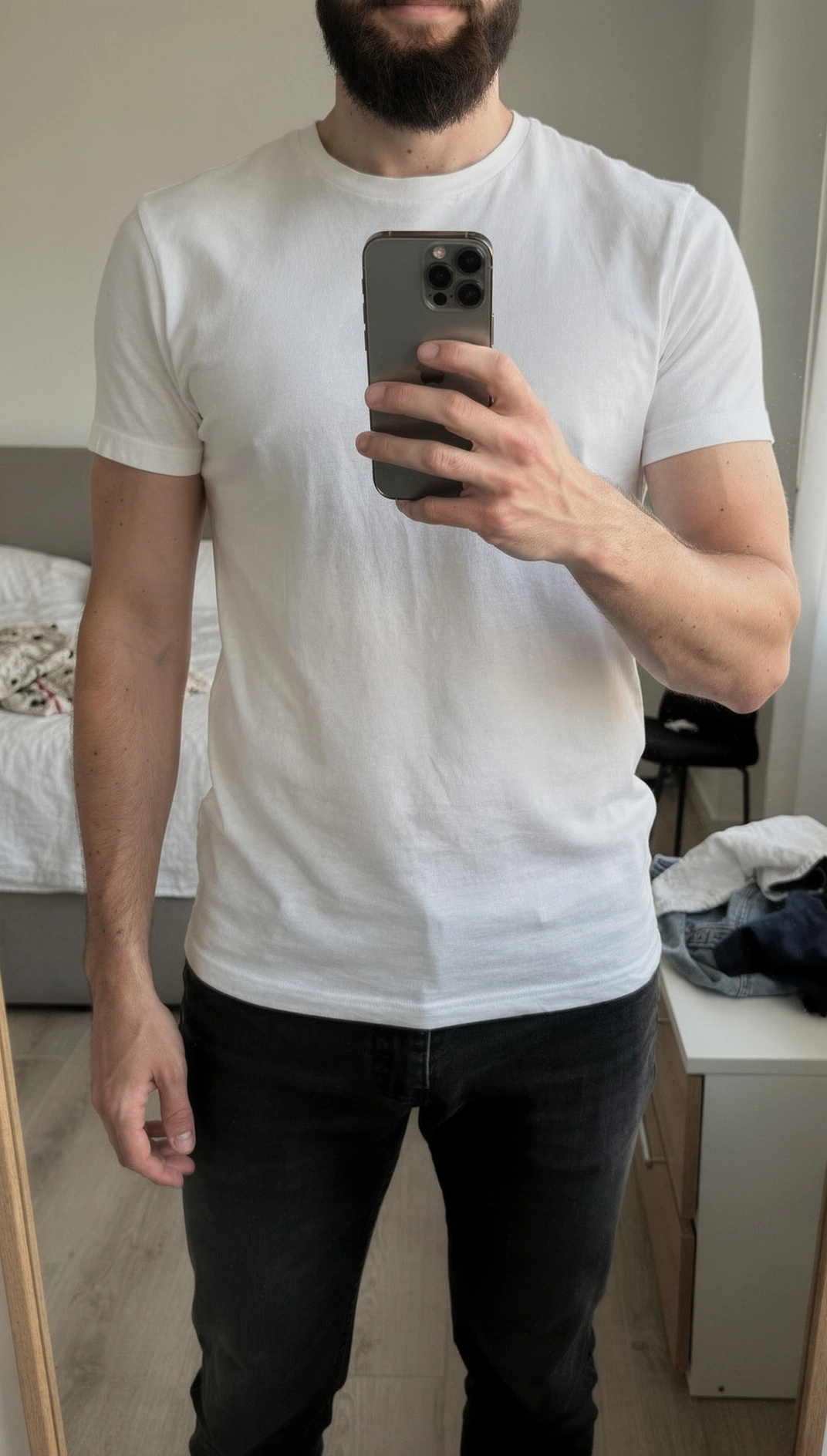 Mirror selfie showing a well-fitted white t-shirt — shoulders and chest sitting just right